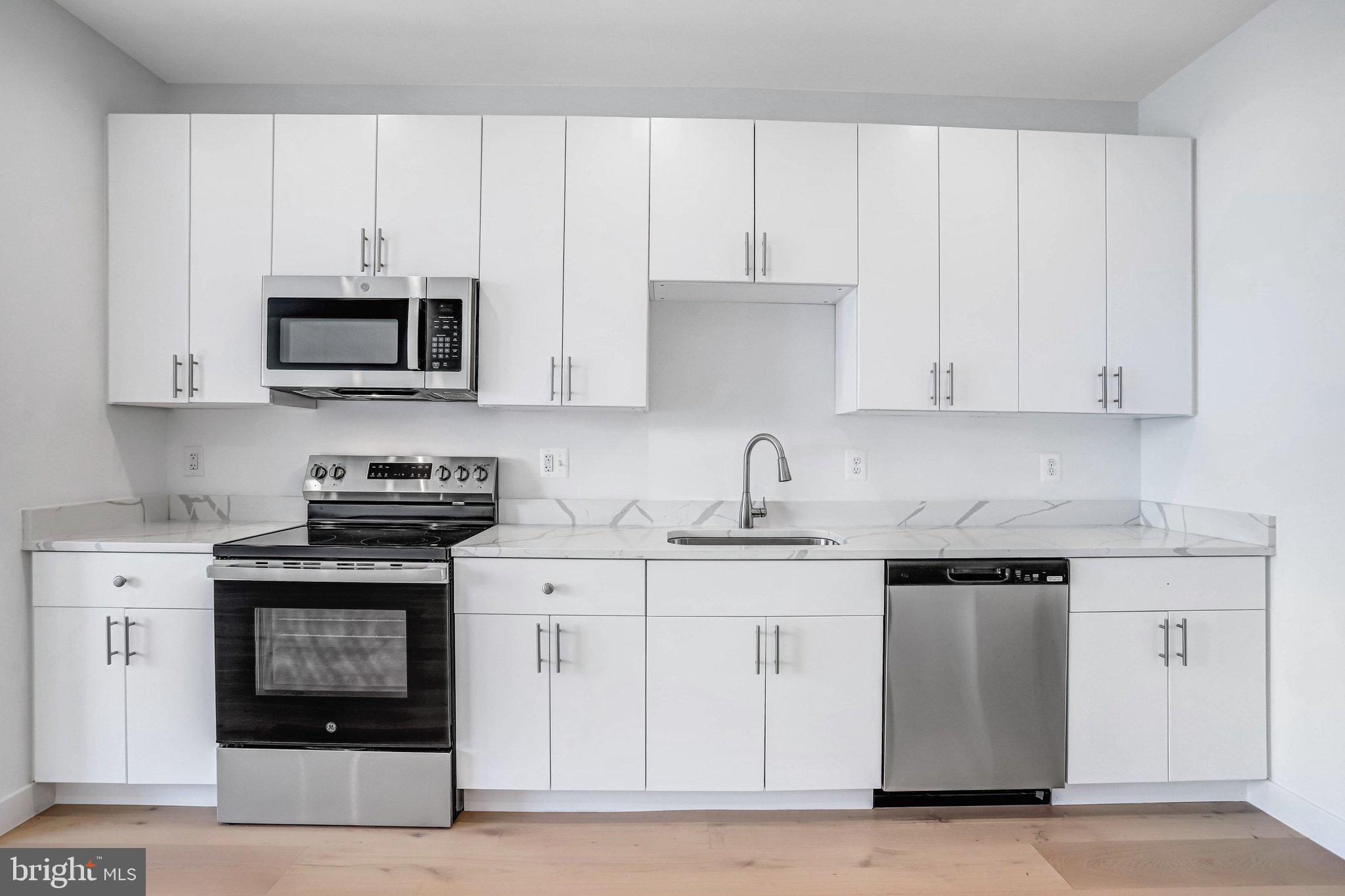 5221 F Street Southeast Washington, DC 20019 - Photo 14 of 63 a kitchen with stainless steel appliances granite countertop a stove a sink and a microwave