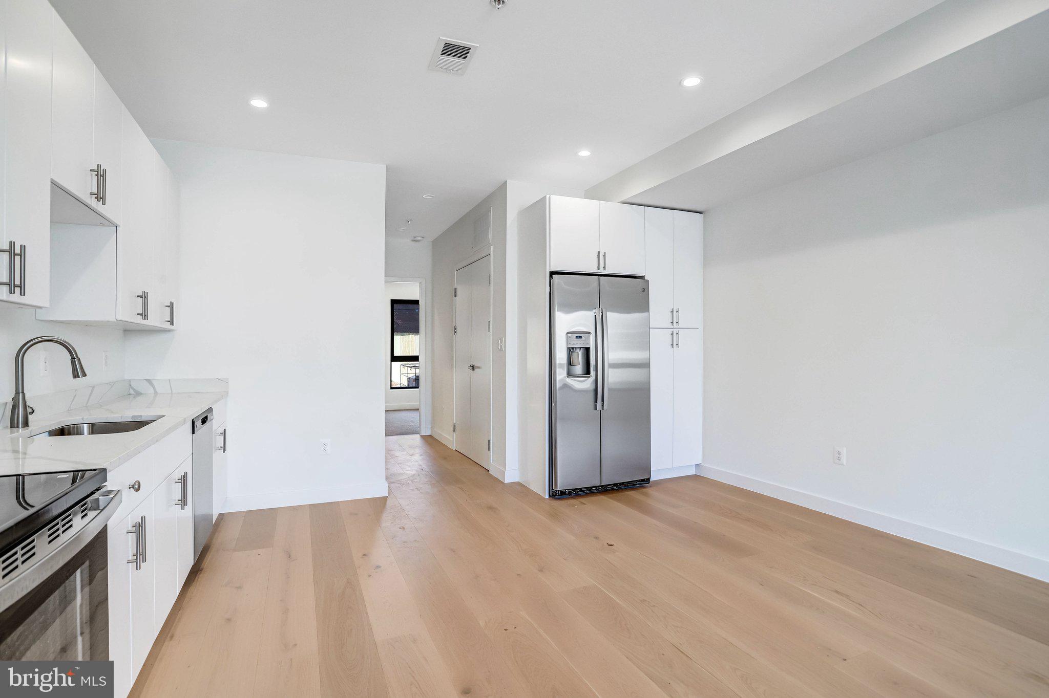 5221 F Street Southeast Washington, DC 20019 - Photo 16 of 63 a view of a kitchen with a sink and dishwasher a refrigerator with wooden floor