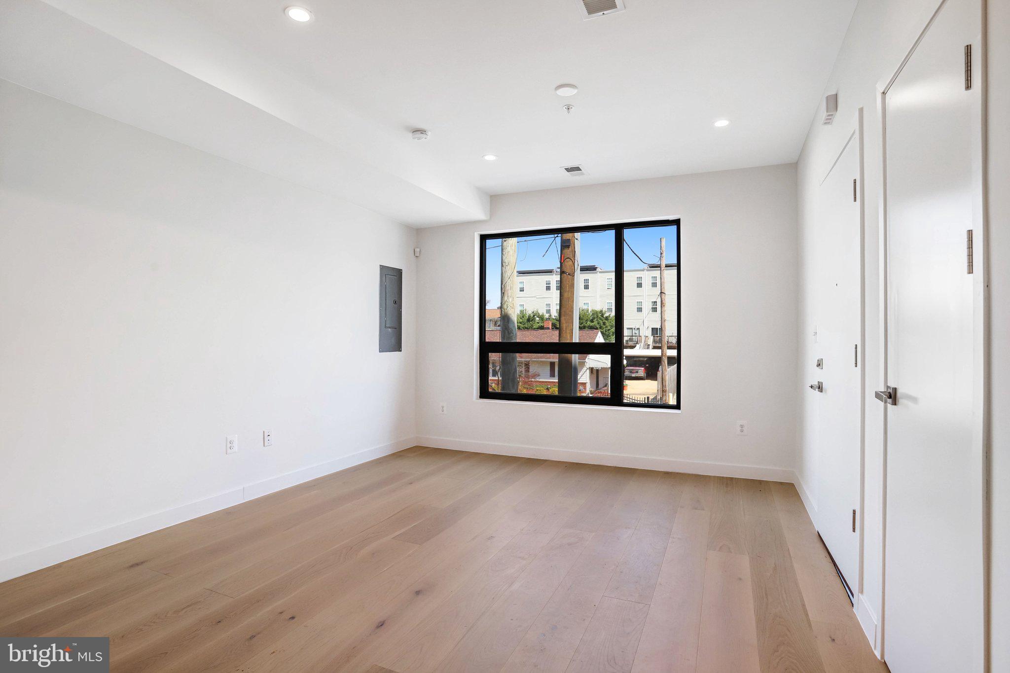 5221 F Street Southeast Washington, DC 20019 - Photo 9 of 63 an empty room with wooden floor and windows