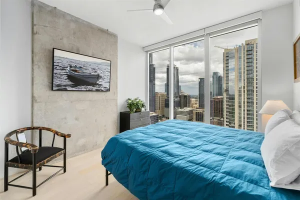 a bedroom with a bed and a painting on the wall