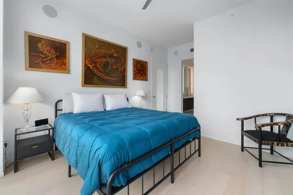 a bedroom with a bed and dresser