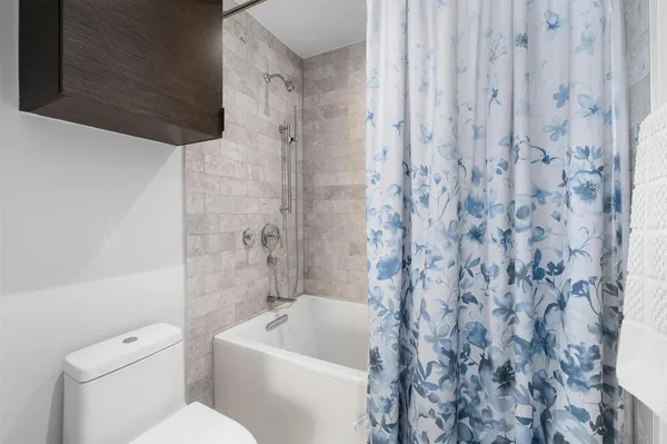 a bathroom with a toilet a sink and bathtub