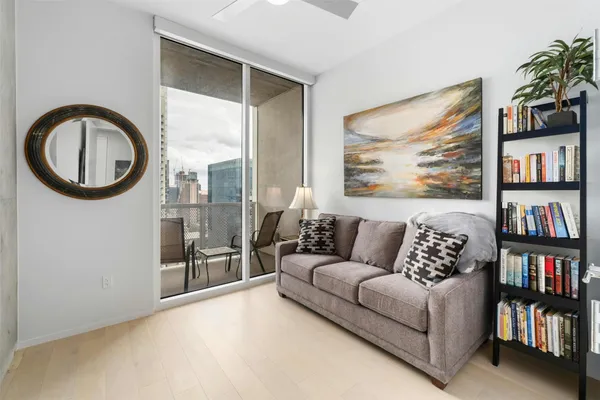 a living room with a couch and a book shelf