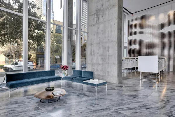 a living room filled with furniture and a floor to ceiling window