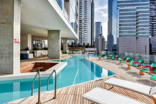 a view of a balcony with dining table and chairs