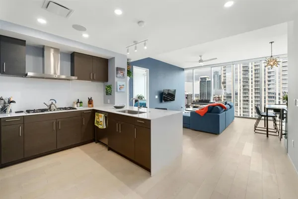 a kitchen with sink refrigerator and cabinets