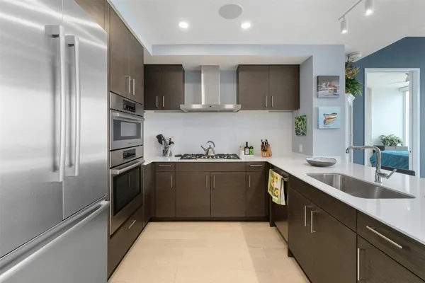 a kitchen with a sink stainless steel appliances and cabinets