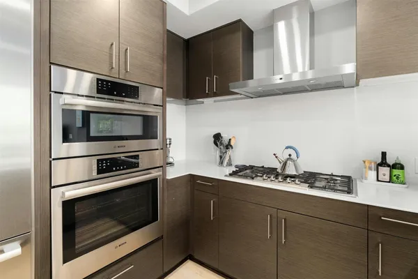 a kitchen with granite countertop cabinets stainless steel appliances and a sink