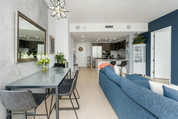 a living room with furniture and chandelier