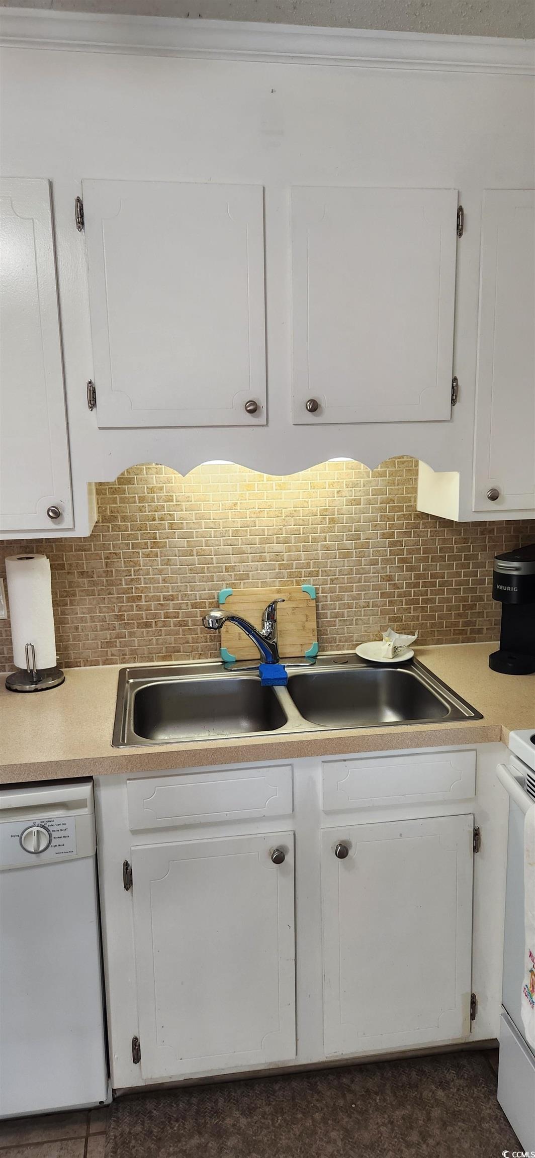 1919 Spring Street, Unit B11 North Myrtle Beach, SC 29582 - Photo 13 of 32 Kitchen featuring tasteful backsplash, white cabin