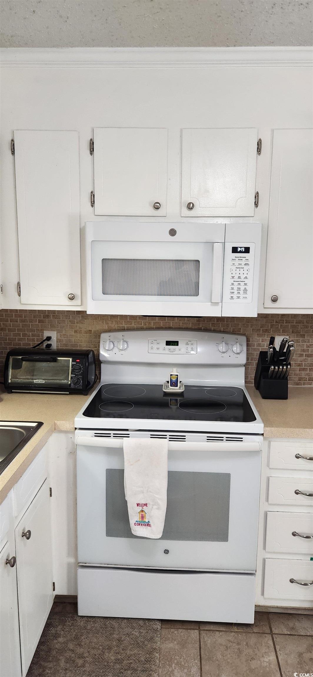1919 Spring Street, Unit B11 North Myrtle Beach, SC 29582 - Photo 14 of 32 Kitchen featuring tasteful backsplash, white cabin