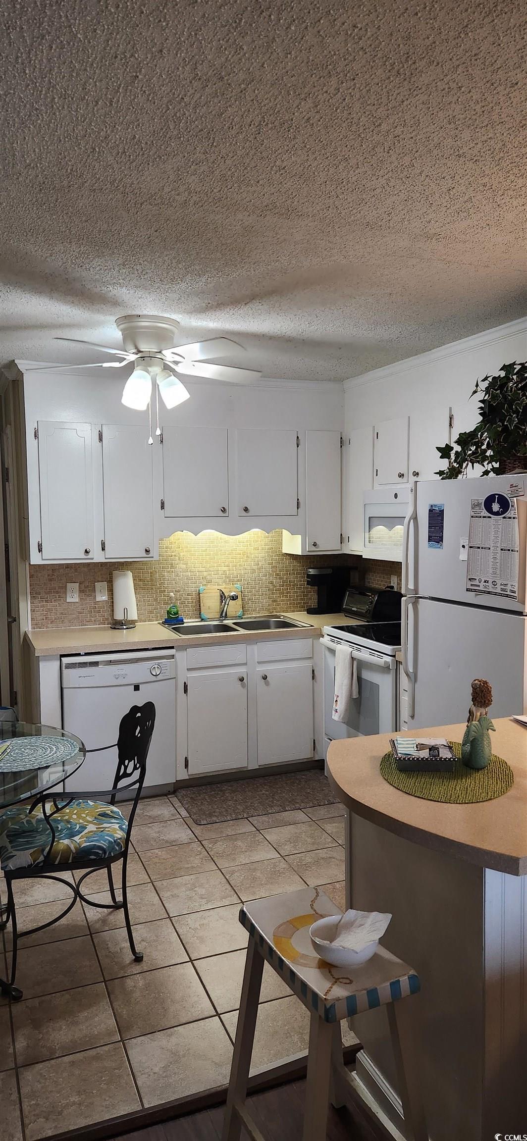 1919 Spring Street, Unit B11 North Myrtle Beach, SC 29582 - Photo 16 of 32 Kitchen featuring sink, white appliances, a textur
