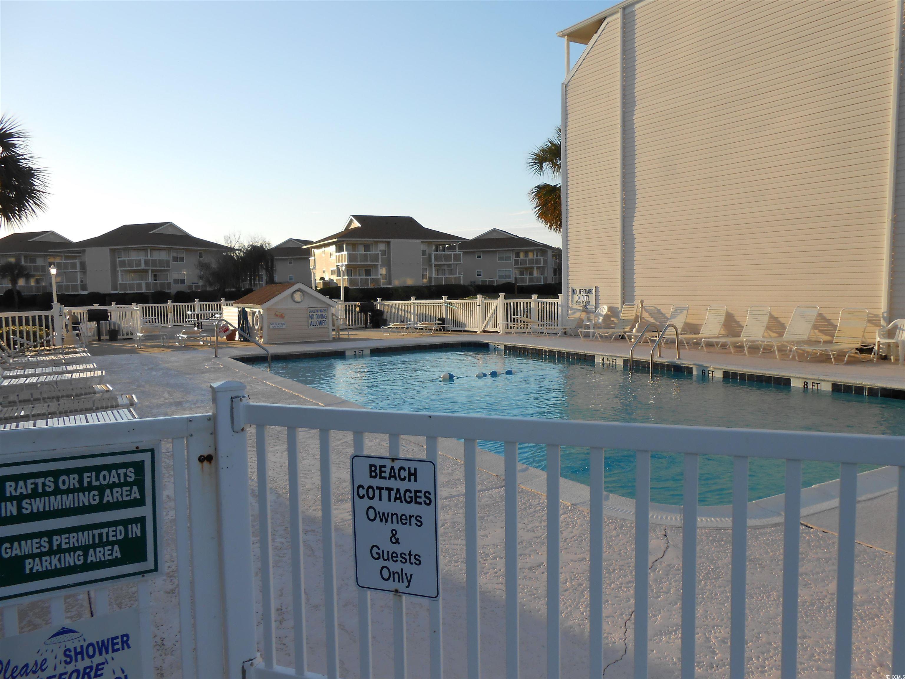 1919 Spring Street, Unit B11 North Myrtle Beach, SC 29582 - Photo 24 of 32 View of pool with a patio area. Rules and Regulati