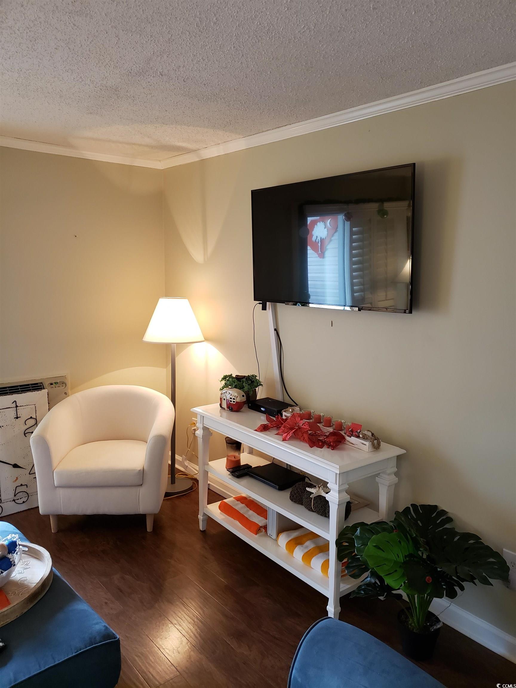 1919 Spring Street, Unit B11 North Myrtle Beach, SC 29582 - Photo 6 of 32 Living room featuring ornamental molding, dark har
