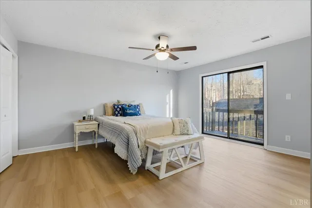 a living room with furniture a large window and a fireplace