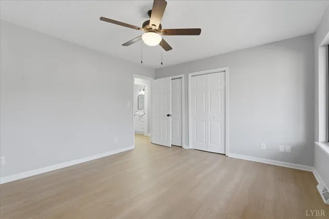 a kitchen with a sink cabinets and wooden floor