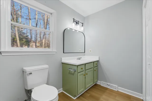 a bathroom with a sink toilet and mirror