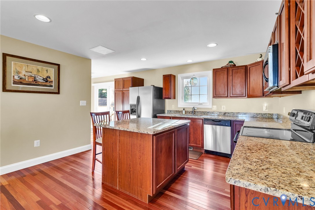 275 Granny's Bar Road Hague, VA 22469 - Photo 21 of 53 a kitchen with stainless steel appliances granite countertop a sink stove and wooden floor