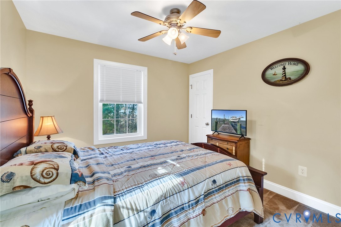 275 Granny's Bar Road Hague, VA 22469 - Photo 39 of 53 a bedroom with a bed and a window