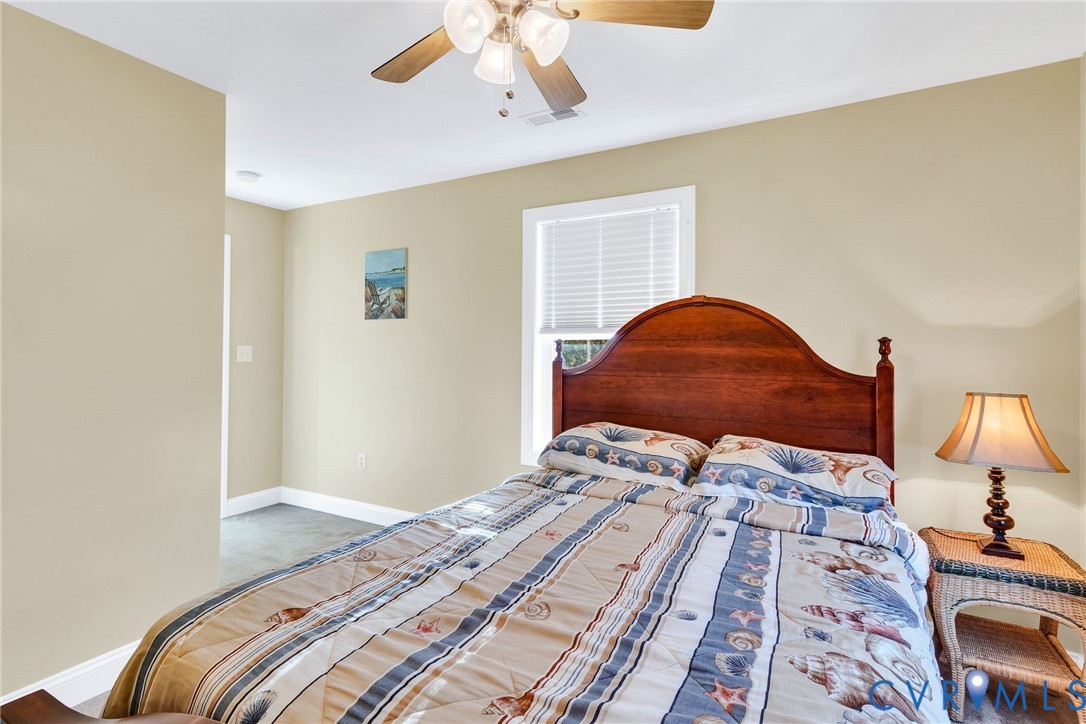 275 Granny's Bar Road Hague, VA 22469 - Photo 40 of 53 a bedroom with a bed and a chandelier