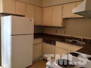 4541 Hargrove Road, Unit AD Raleigh, NC 27604 - Photo 7 of 22 a kitchen with a refrigerator and a sink