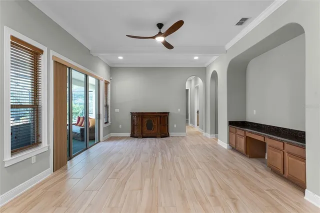 a large kitchen with stainless steel appliances kitchen island a large counter top and wooden floors