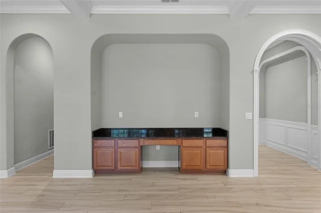 a workspace with wooden floor and a window