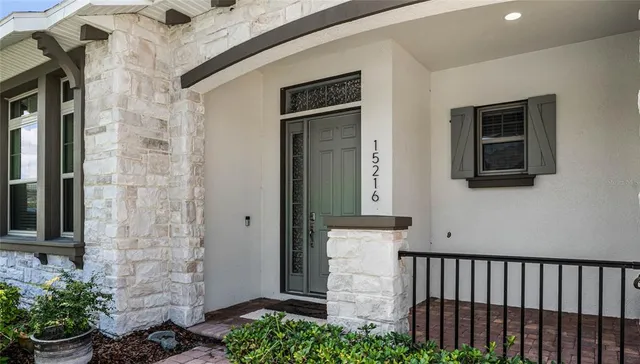 a view of a door and brick wall