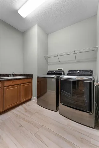 a spacious bathroom with a sink a mirror a bathtub and next to a window