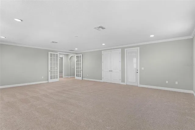 an empty room with a window and ceiling fan