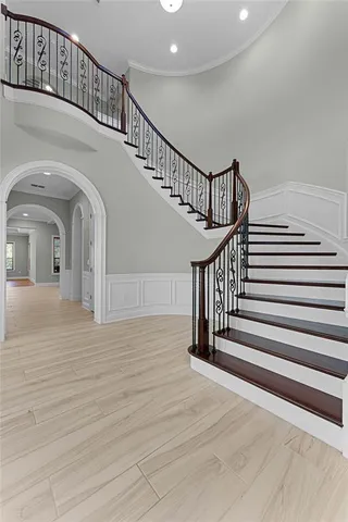 a view of entryway and hall with wooden floor