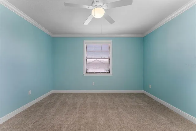 an aerial view of a houses with outdoor space and a lake view in back