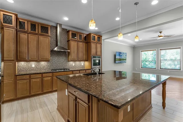 a view of an empty room with window and a kitchen