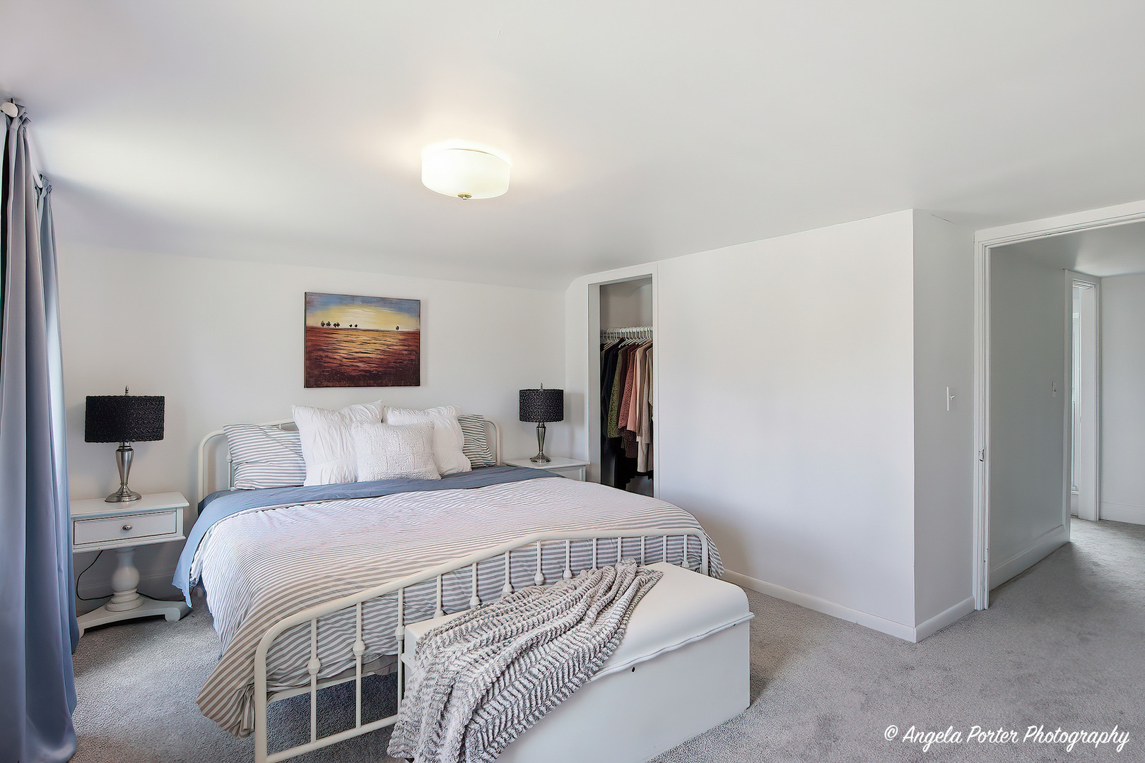 9703 Illinois Street Hebron, IL 60034 - Photo 27 of 30 a bedroom with a bed a mirror and a lamp