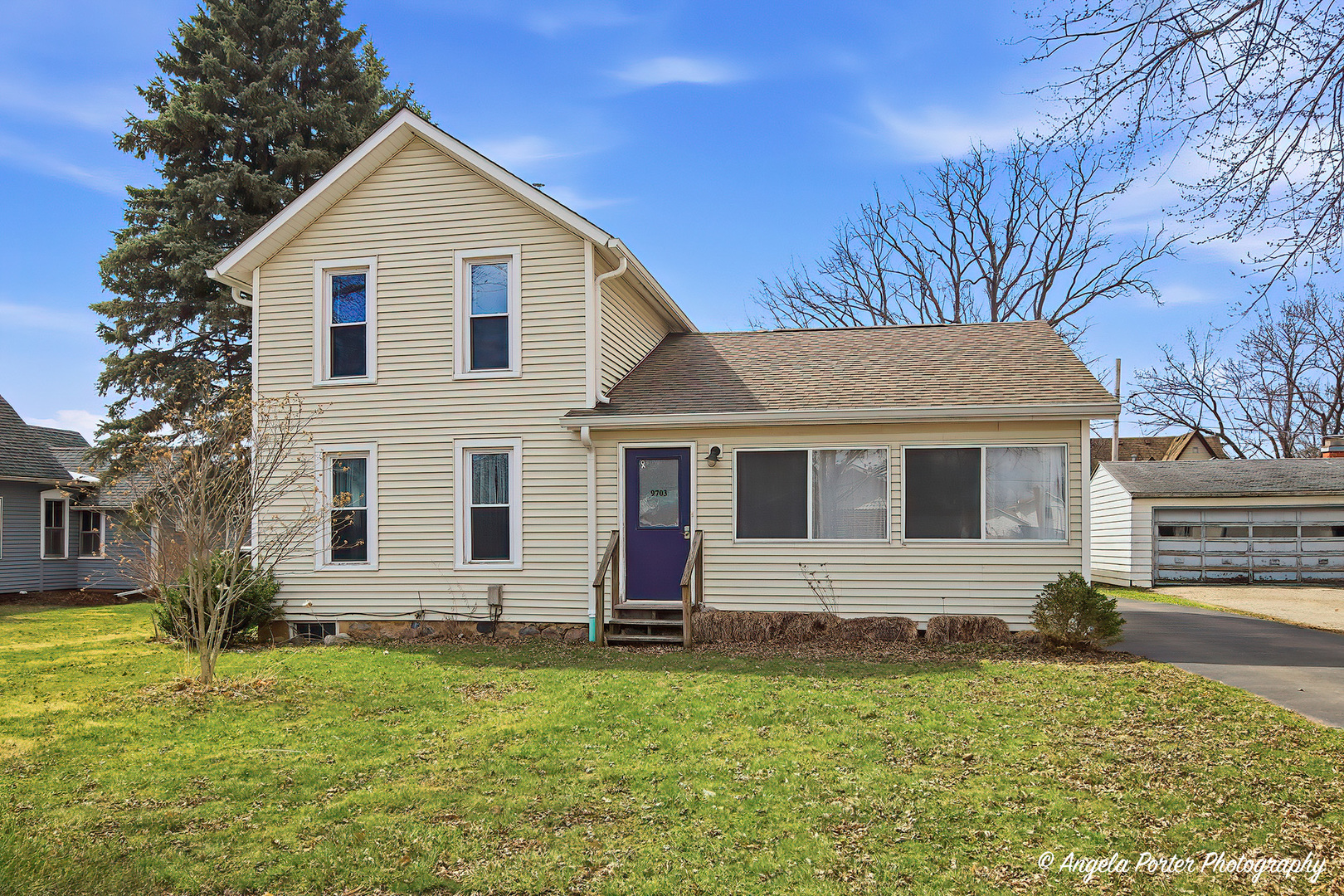 9703 Illinois Street Hebron, IL 60034 - Photo 3 of 30 a view of a yard in front of a house with plants and large tree