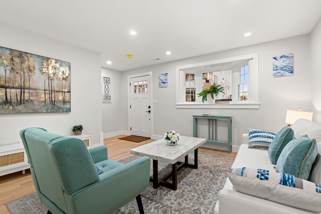 35 Dewey Street, Unit 35 Boston, MA 02125 - Photo 13 of 30 a living room with furniture and a painting on the wall
