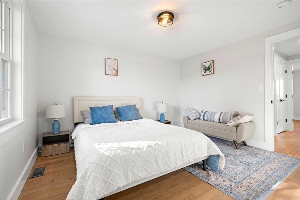 35 Dewey Street, Unit 35 Boston, MA 02125 - Photo 15 of 30 a bedroom with bed and a couch