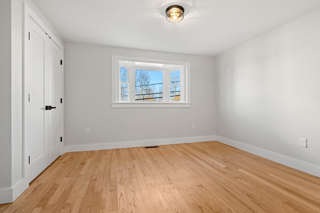 35 Dewey Street, Unit 35 Boston, MA 02125 - Photo 19 of 30 a view of empty room with wooden floor