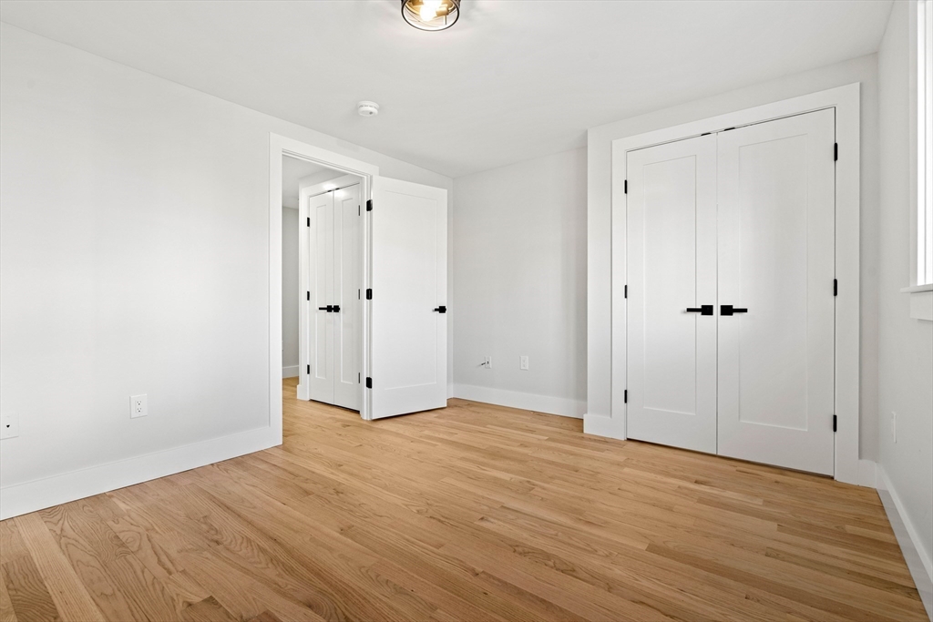 35 Dewey Street, Unit 35 Boston, MA 02125 - Photo 20 of 30 a view of an empty room with wooden floor