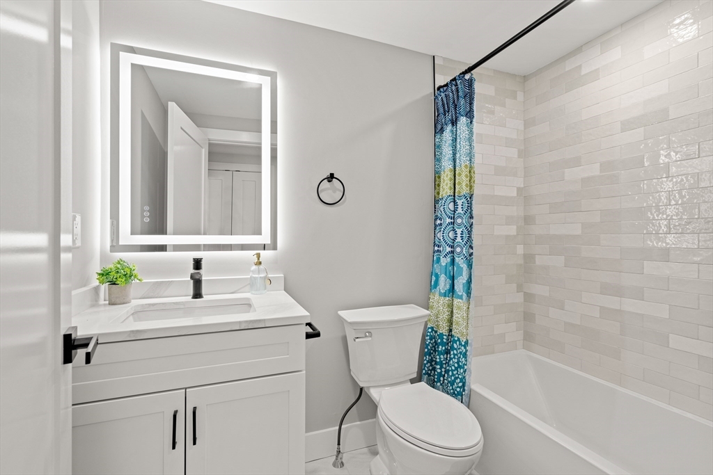 35 Dewey Street, Unit 35 Boston, MA 02125 - Photo 22 of 30 a bathroom with a sink toilet and shower