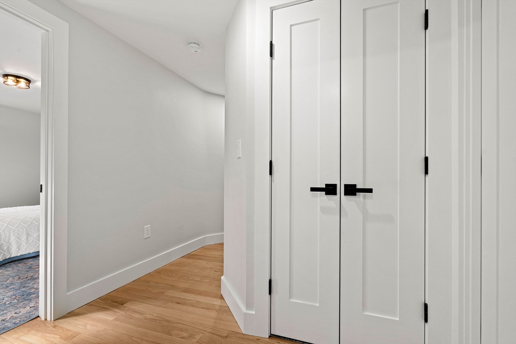 35 Dewey Street, Unit 35 Boston, MA 02125 - Photo 25 of 30 a view of a hallway with wooden floor