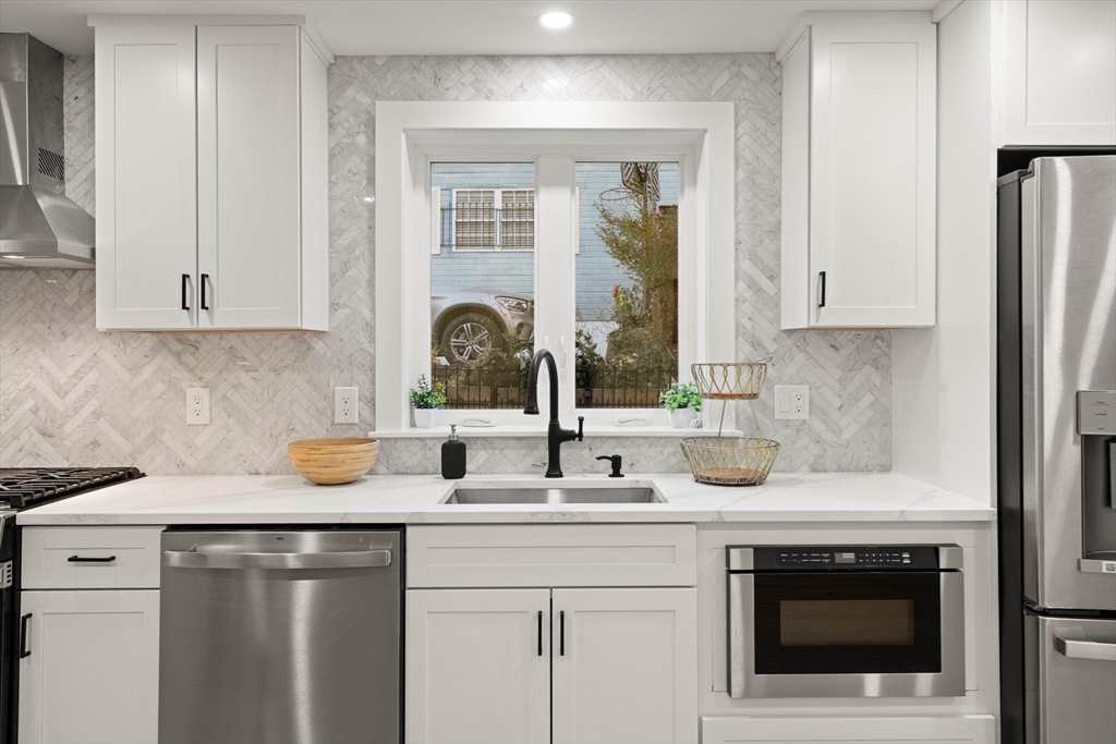 35 Dewey Street, Unit 35 Boston, MA 02125 - Photo 6 of 30 a kitchen with a sink stove and cabinets