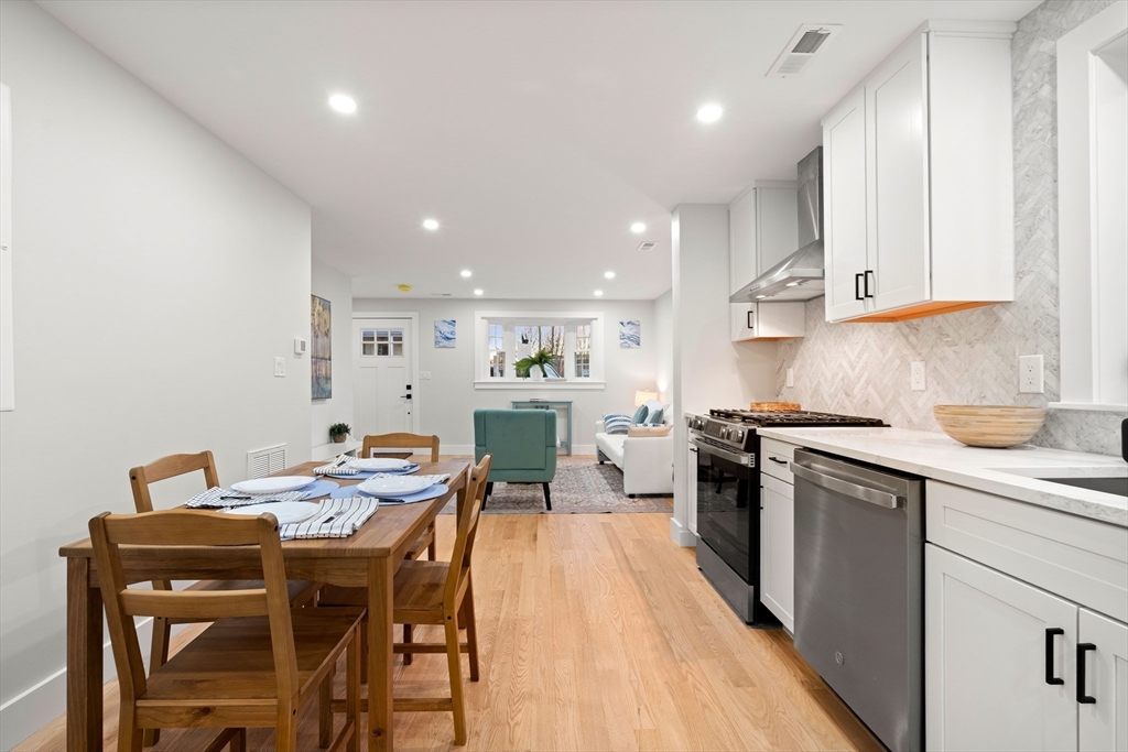 35 Dewey Street, Unit 35 Boston, MA 02125 - Photo 9 of 30 a kitchen with stainless steel appliances kitchen island granite countertop a sink and cabinets