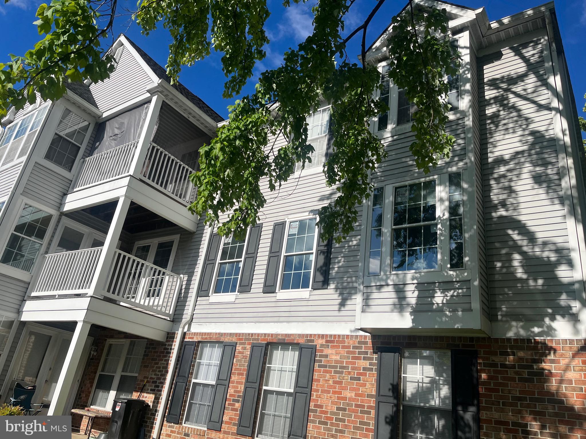 a front view of a building with a garden