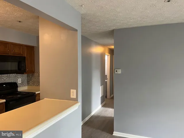a view of a kitchen from the hallway