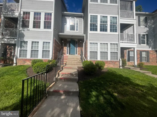 a view of a house with a yard and plants