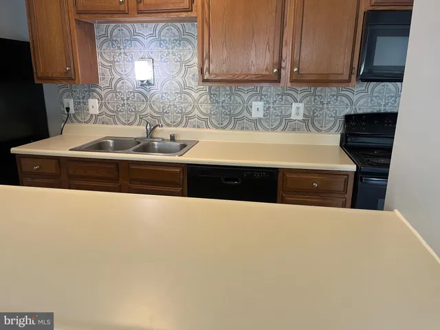 a kitchen with granite countertop a sink and a stove