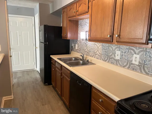 a kitchen with a sink and a refrigerator