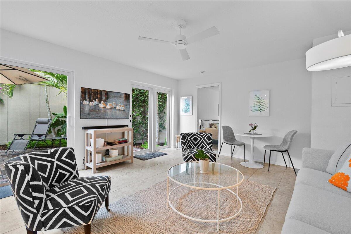1605 Highway 1, Unit 7C Jupiter, FL 33477 - Photo 13 of 31 a living room with furniture a flat screen tv and a large window