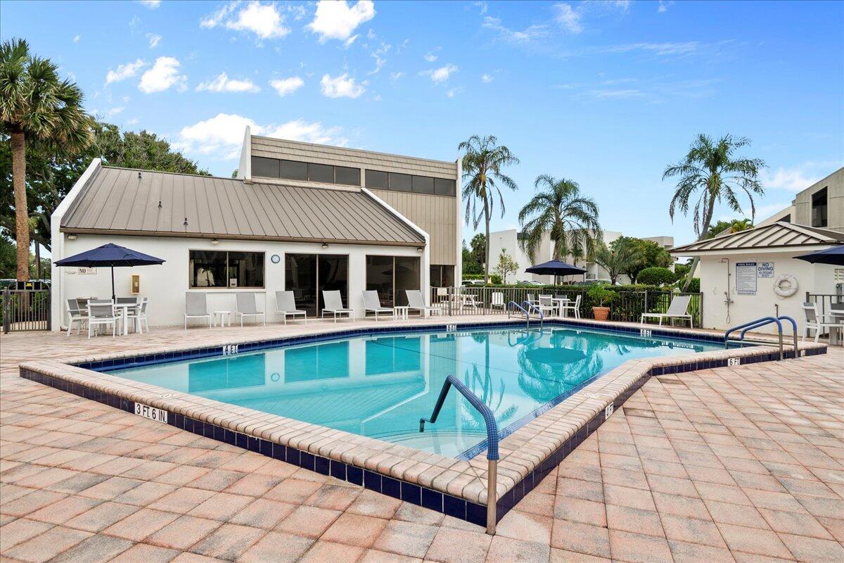 1605 Highway 1, Unit 7C Jupiter, FL 33477 - Photo 27 of 31 a view of a house with swimming pool and sitting area